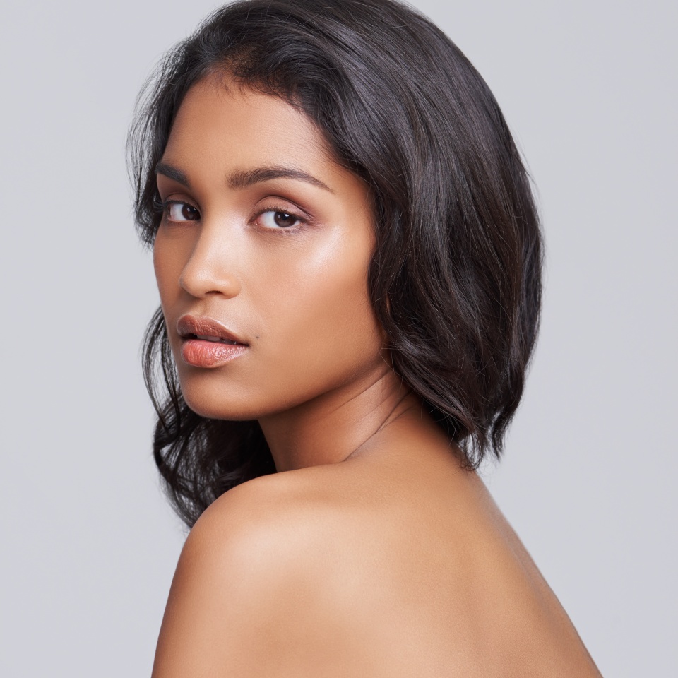 All natural beauty. Shot of a beautiful young posing over a gray background.