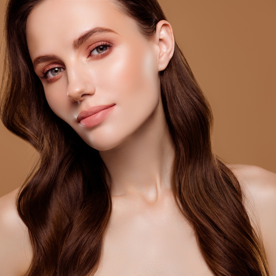 Portrait of pretty charming lady enjoying new cream lotion for pure perfect skin on pastel color background